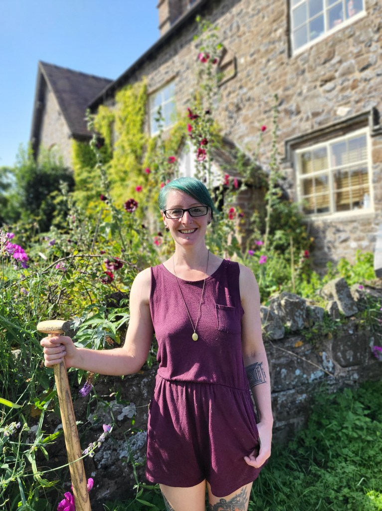 Me standing in the garden holding a fork